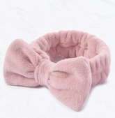 Pink plush headband on a white background